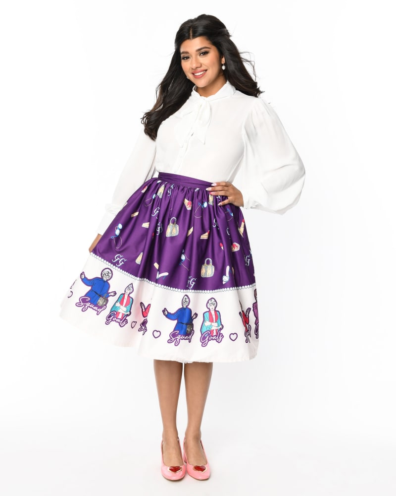 Front of a model wearing a size L The Golden Girls x Unique Vintage Purple Character Border Gellar Swing Skirt in Purple Golden Girls Print by Unique Vintage. | dia_product_style_image_id:325170